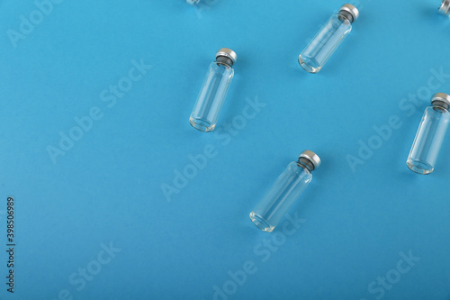 vaccine vials are on blue medical background top view
