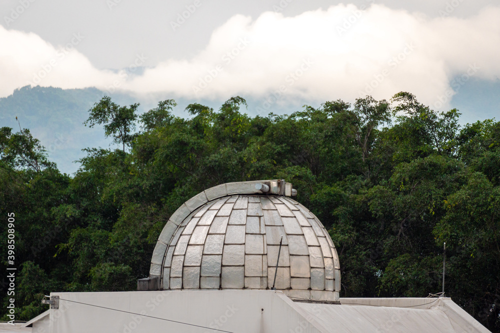 Dome on a Roof Similar to an Observatory Surrounded of Trees Dome on a Roof Similar to an Observatory Surrounded of Trees