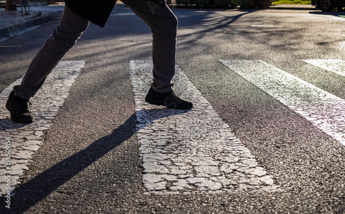 Obsessive compulsive disorder, man trying not to step on the black lines of a pedestrian crossing