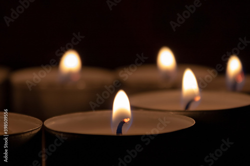 Burning candles with copy space on black background