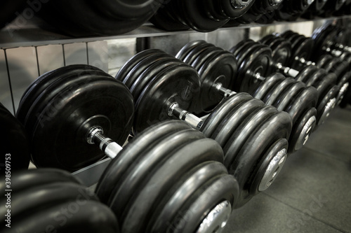 Row of heavy dumbbells in the gym. Active lifestyle and sports.