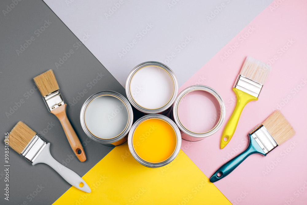 Demonstrating colors of year 2021 - Gray and Yellow. Four open cans of paint with brushes on bright background. - obrazy, fototapety, plakaty 
