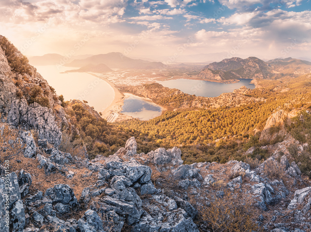 Scenic aerial paniramic view from mountain Bozburun to Iztuzu beach and the Dalyan river Delta as well as lake Sulungur at sunset time. Majestic autumn landscape. Explore natural wonders of Turkey