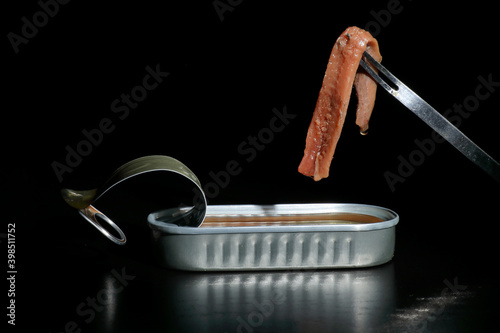 Cantabrian anchovies in can with black background
