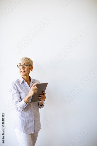 Mature businesswoman using ...