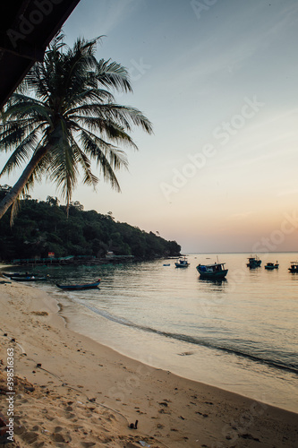 Fototapeta Naklejka Na Ścianę i Meble -  Typical sunset landscape in Vietnam on the island of Phu Quoc, local fishing boats anchored in the bay