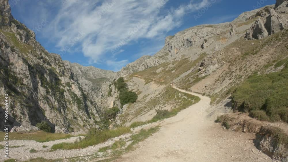 DOLLY SHOT - The Cares Route in the heart of Picos de Europa National Park, Cain-Poncebos, Asturias, Spain. Narrow and impressive canyon between cliffs, bridges, caves, footpaths and rocky mountains. DOLLY SHOT - The Cares Route in the heart of Picos de Europa National Park, Cain-Poncebos, Asturias, Spain. Narrow and impressive canyon between cliffs, bridges, caves, footpaths and rocky mountains.
