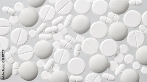 Various white medical pills on white background © natagolubnycha
