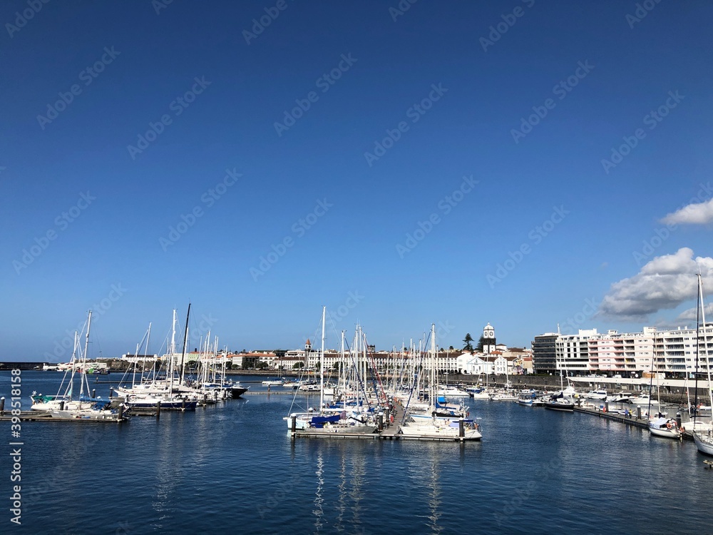 View over the Marina of the City of Ponta Delgada, with with anchored boats and yachts. São Miguel Island. Azores, Portugal