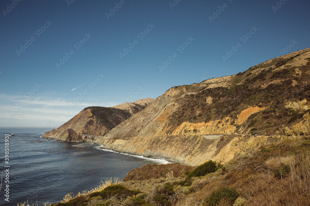 America, California 1st highway from Los Angeles to San Francisco. Sunny day, with big ocean waves, on the steep bank