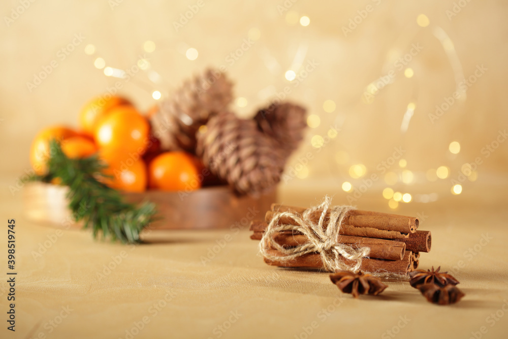 Chrismas mood still life: cinnamon, anise, tangerines, pine cones in golden christmas lights Chrismas mood still life: cinnamon, anise, tangerines, pine cones in golden christmas lights