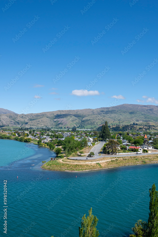 Central Otago town of Cromwell on bend in turquoise  Clutha River in Central Otago New Zealand.
