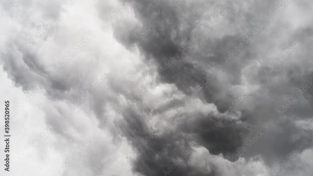 zoom in in a thunderstorm inside the gray and dark cumulus cloud