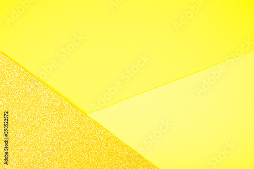 Abstract paper geometric background in shades of yellow. Color of the year 2021 illuminating