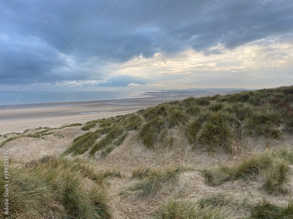Camber sands beach, Rye, East Sussex UK, Camber is a flat sandy beach with giant sand dunes on South coast England and popular with tourists and daytrippers in Summer 