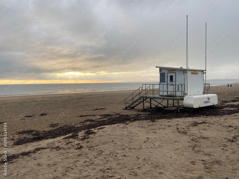 Camber sands beach, Rye, East Sussex UK, Camber is a flat sandy beach with giant sand dunes on South coast England and popular with tourists , lifeguard tower hut 