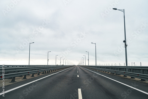 Empty highway with asphalt road and cloudy sky