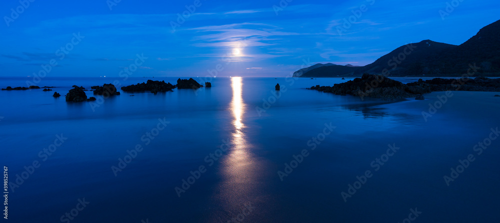 The Moon in Trengandin beach, Noja, Marismas de Santoña, Noja y Joyel Natural Park, Cantabrian Sea, Cantabria, Spain, Europe
