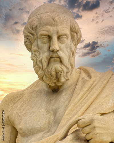 Plato the ancient Greek philosopher statue under dramatic sky, Athens Greece .