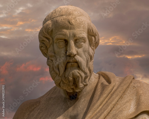 Plato the ancient Greek philosopher statue under dramatic sky, Athens Greece. © Dimitrios