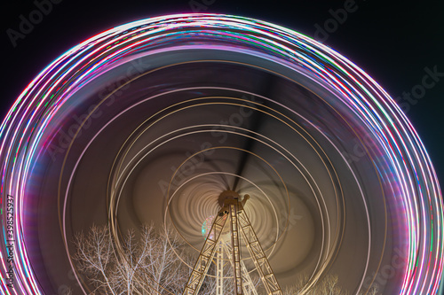 Fonte Nova's garden with Christmas market and colored ferris wheel near Ria de Aveiro at night