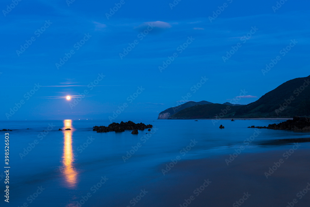 Fototapeta premium The Moon in Trengandin beach, Noja, Marismas de Santoña, Noja y Joyel Natural Park, Cantabrian Sea, Cantabria, Spain, Europe