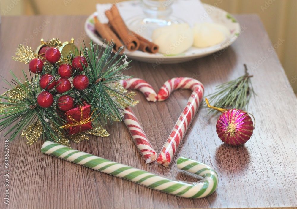 christmas candy lollipop on a wooden table and Christmas ball and gift