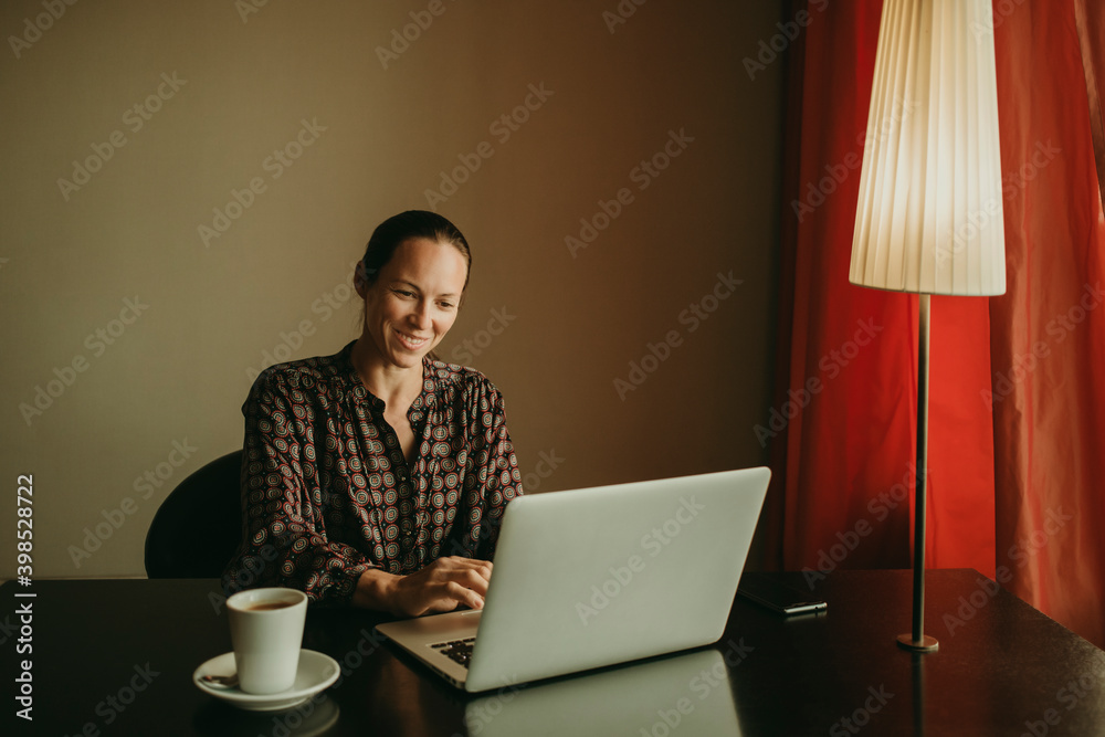Female entrepreneur smiling while working in office Female entrepreneur smiling while working in office