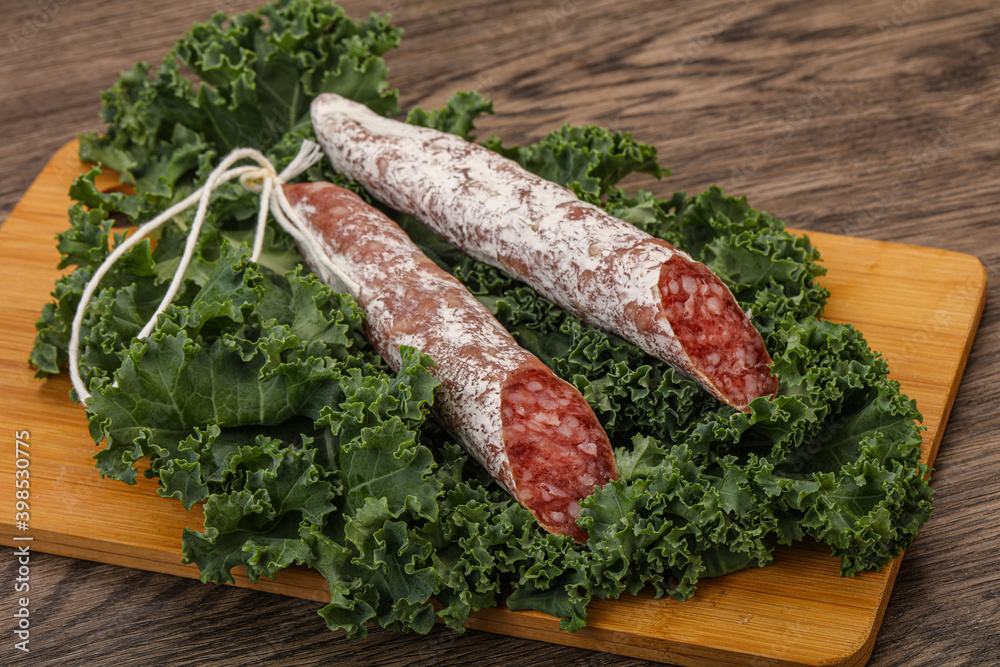 Spanish Fuet sausage with salad leaves Spanish Fuet sausage with salad leaves