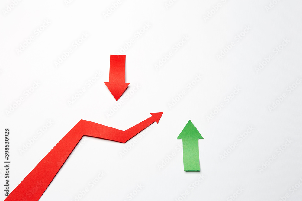 Red color arrow cutted from paper made as graph showing growth of stock market or business progress on the white background with two red and green paper arrows showing growth and drops Red color arrow cutted from paper made as graph showing growth of stock market or business progress on the white background with two red and green paper arrows showing growth and drops