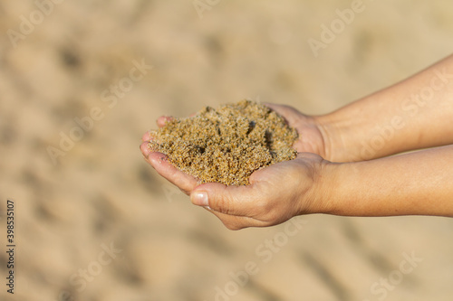 Girl’s hands playing with sand with clear background