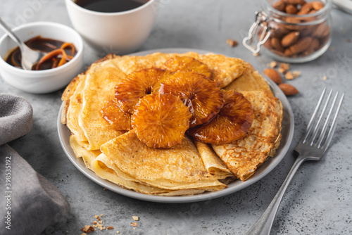 Traditional French thin pancakes crêpe suzette with orange sauce. Morning breakfast dessert photo