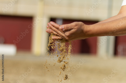 Girl’s hand playing with sand with clear background