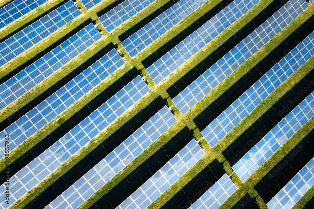 Aerial view of solar panels on a sunny day. power farm producing clean energy. High quality photo. Aerial view of solar panels on a sunny day. power farm producing clean energy. High quality photo.