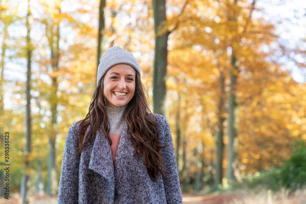 Beautiful female hiker standing in Cannock Chase forest during autumn Beautiful female hiker standing in Cannock Chase forest during autumn