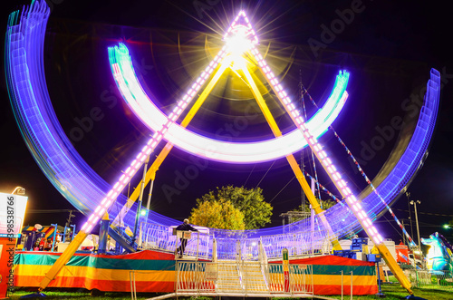 Long Exposure of a pirate ship at a fairground with light trails © Andrew
