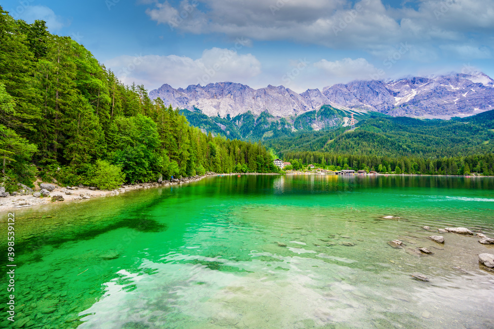 Eibsee lake with Zugspitze mountain in the background. Beautiful landscape scenery with paradise beach and clear blue water in German Alps - Garmisch Partenkirchen, Grainau - Bavaria, Germany, Europe.