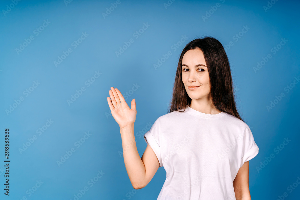 Young girl show with hand empty space isolated on blue Young girl show with hand empty space isolated on blue