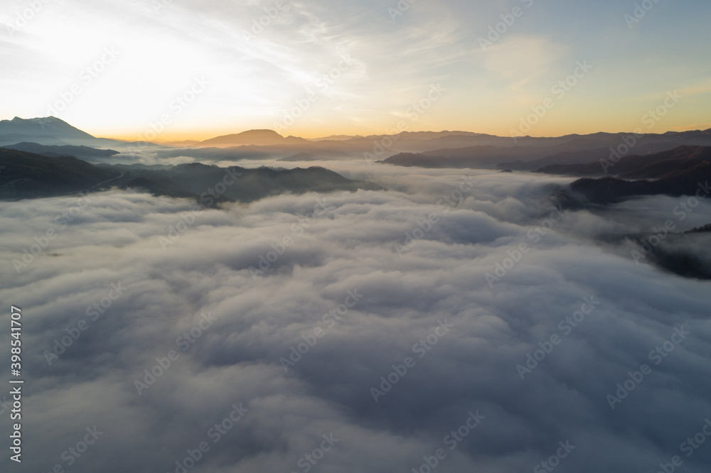 Flying through the clouds at dawn above the jumping lake in Rieti