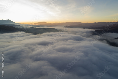 Flying through the clouds at dawn above the jumping lake in Rieti