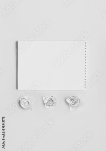 Festive concept with notebook and rosebuds on Gray background. Valentines Day. Template mock up of greeting card or text desi Colors of the year 2021- Graygn.