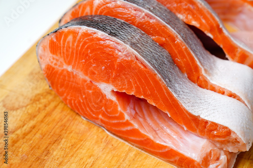 salmon sliced into pieces on a wooden cutting Board. red fish. fresh trout for cooking.