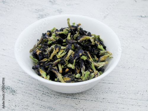 Blue anchan tea leaves in a white bowl. Leaves of the clitoris trifoliate.