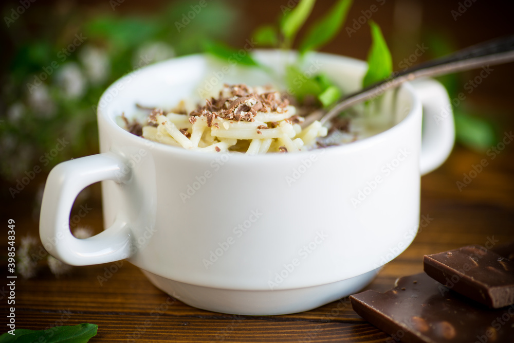 sweet noodles with milk and grated chocolate in a bowl sweet noodles with milk and grated chocolate in a bowl