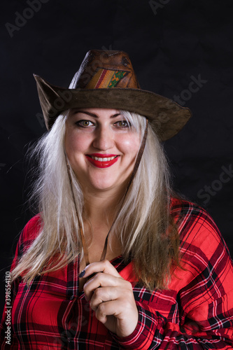 Attractive plump woman dressed in cow boy style photo