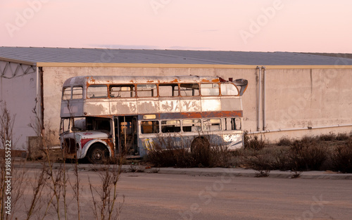 OLD TWO STORY BUS DESTROYED IN THE MIDDLE OF THE FIELD photo