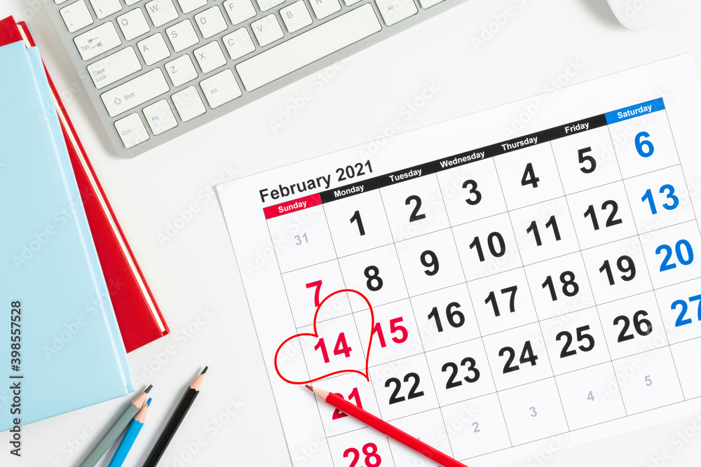 Valentine's Day background. Office table. Date February 14 on calendar 2021, Valentine's Day red heart circled. Flat lay, top view, copy space Valentine's Day background. Office table. Date February 14 on calendar 2021, Valentine's Day red heart circled. Flat lay, top view, copy space