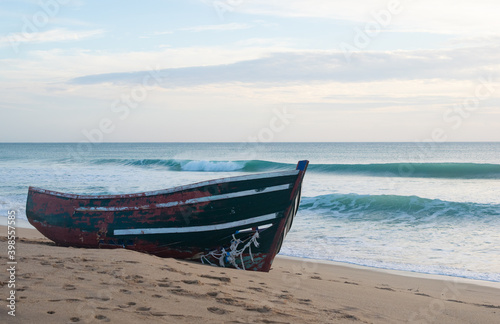 Wooden patera immigrant boat stranded at the Mangueta beach in Zahora, south Spanish Atlantic coast. photo