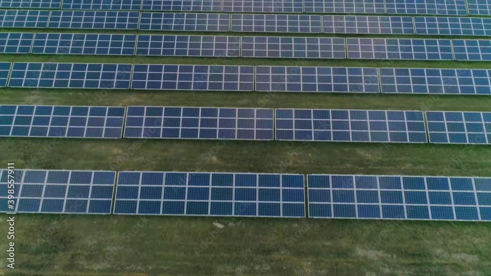 Aerial top view of large solar power station sun panels standing in rows. Concept of green renewable energy, future innovations and technology. Aerial top view of large solar power station sun panels standing in rows. Concept of green renewable energy, future innovations and technology.