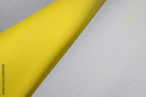 Top view of wavy yellow gray colored background made from mat for yoga or sports. Trendy colors 2021 year.  Yoga pilates sport concept. Flat Lay. Copy space. 